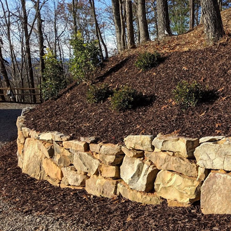Tiered modular block retaining wall on a sloped calhoun ga backyard